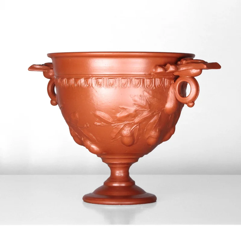 Tasse à vin romain avec reliefs de glands et manche - céramique sigillée