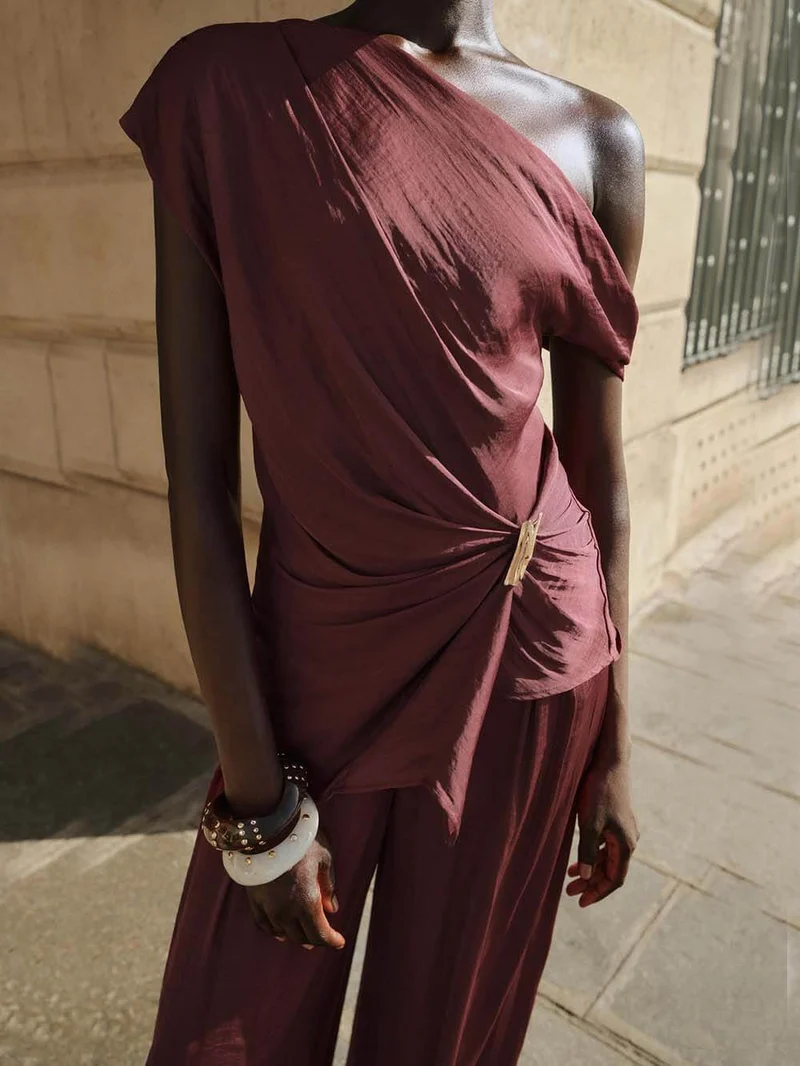 Unique Asymmetric Hem Metallic Accents Top